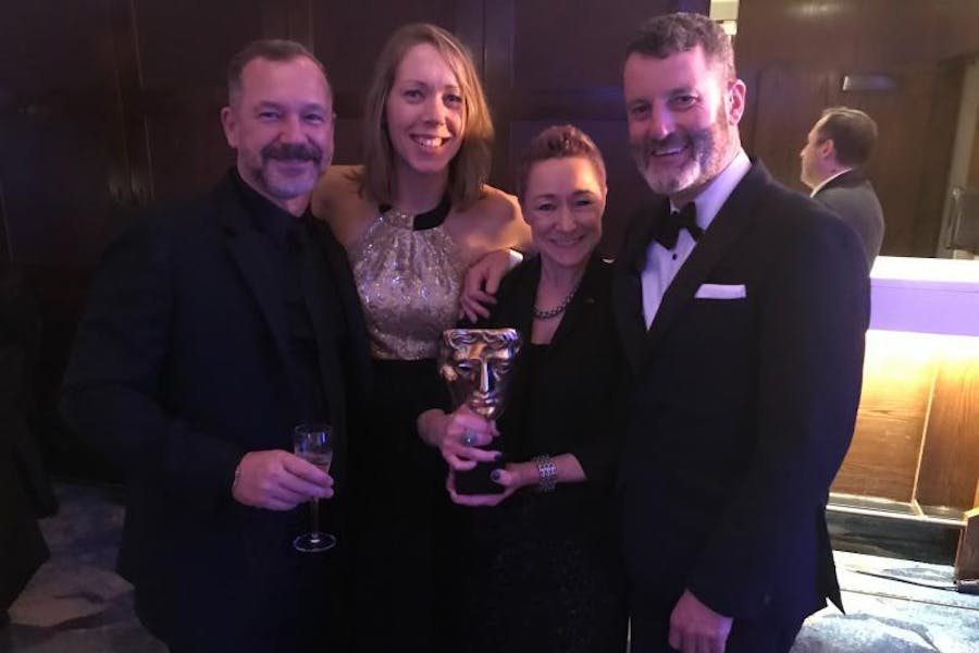 Chloe Chesterton celebrating with the 1917 team at the 2020 BAFTAs